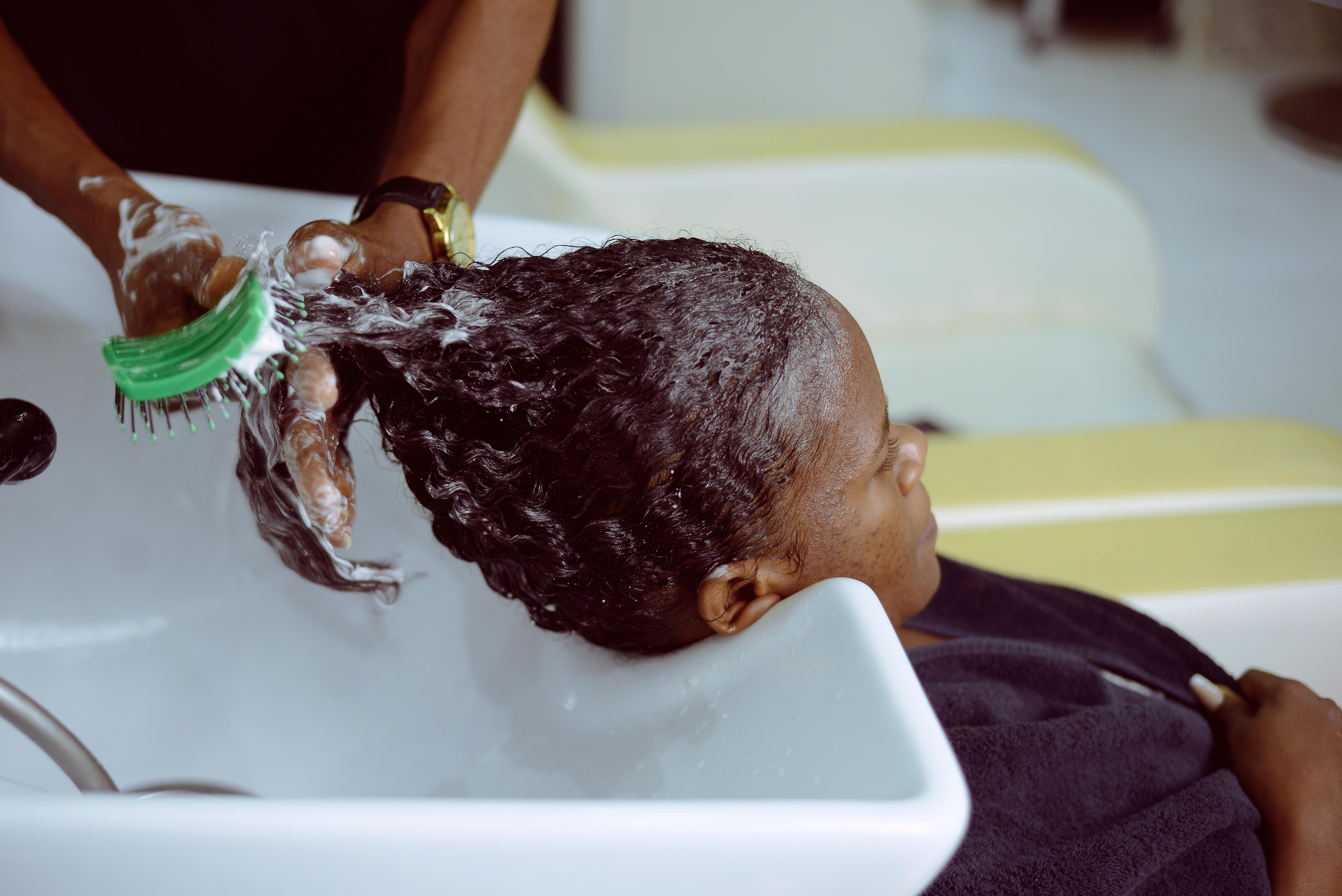 Washing Woman Hair at Hairdresser